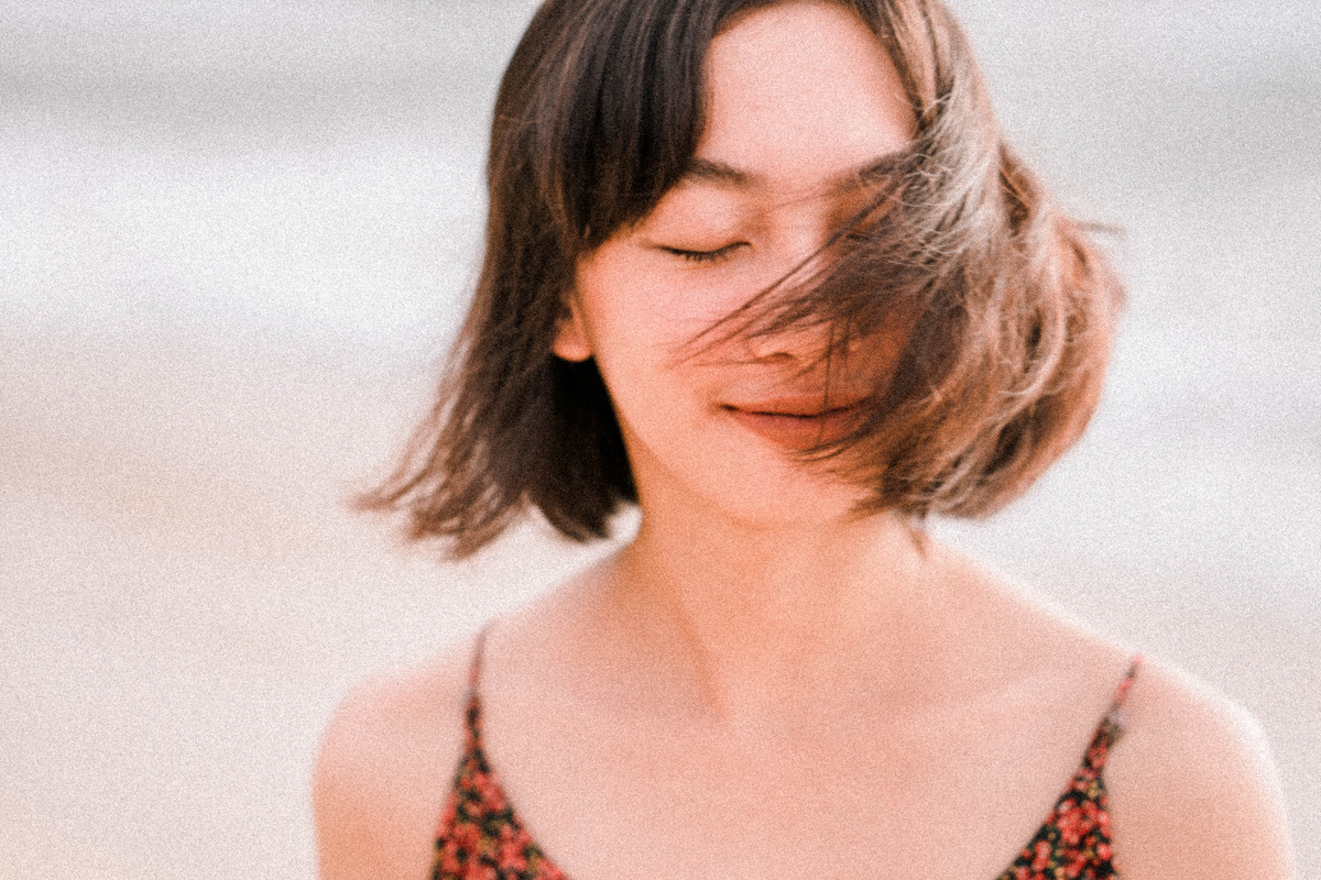 Calm ethnic woman waving with short hair