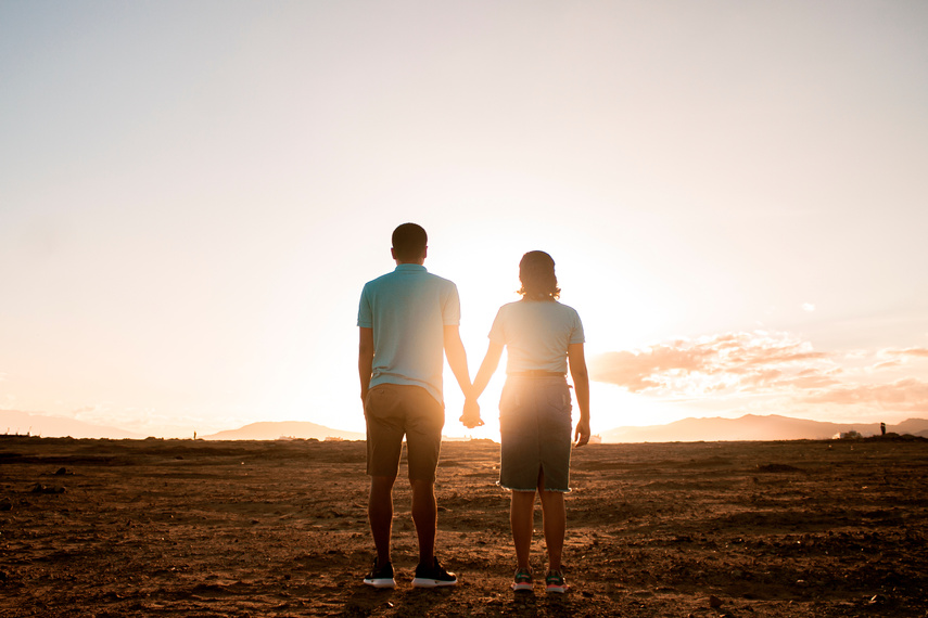 Couple Standing on Field During Golden Hour